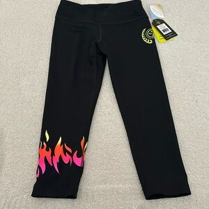Zumba Capri Leggings. Black with flames on right leg. Size XSpicy (XS). NWT